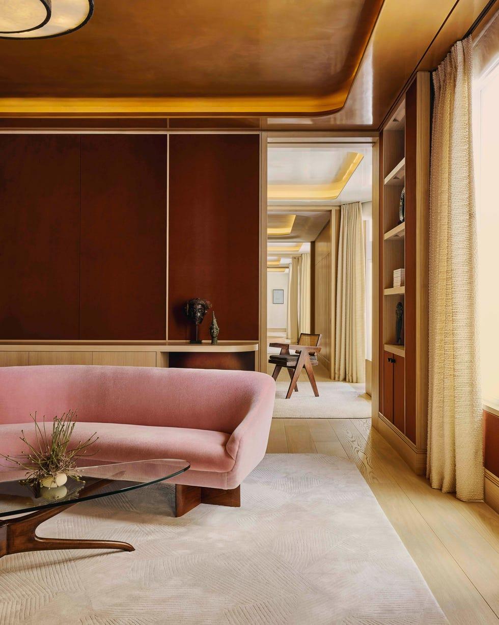 Studio Indigo interior — a panelled salon with a rose velvet sofa and brass ceiling detail